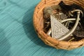 Partial wooden imitation jewelry basket kept on a blue textured background