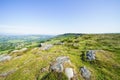 Many partially buried gritstone rocks litter the top of Baslow Edge Royalty Free Stock Photo