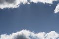 Partially cloudy blue sky with wisps of white and gray clouds Royalty Free Stock Photo