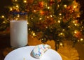 Partially eaten cookie by a Christmas tree Royalty Free Stock Photo