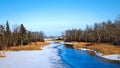 Partially frozen Mississippi River flows north toward Bemidji Minnesota in winter