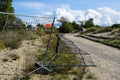 Partially overturned mobile steel fence with concrete base blocks to limit the area Royalty Free Stock Photo