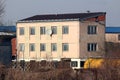 Partially renovated old office building in old part of town with new roof tiles and satellite dish on one side Royalty Free Stock Photo