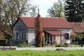 Partially renovated very old small suburban family house with dirty dilapidated facade and new roof tiles Royalty Free Stock Photo