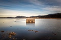 Abandoned and partially submerged stone building in lake in Corsica