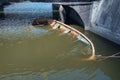 Partially sunken boat in the muddy water