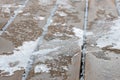 Partially thawed snow and ice covered wooden deck