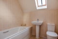 Partially tiled modern bathroom and toilet