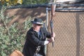 Participant dressed in period cowboy costume, portraying gunfig