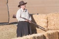 Participant dressed in period cowboy costume, portraying gunfig