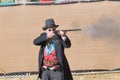 Participant dressed in period cowboy costume, portraying gunfig