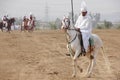 A participant on horse in a tent pegging event