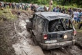 Participant on Jeep passes a deep muddy pit.