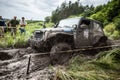 Participant on Jeep passes a deep muddy pit.