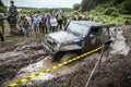 Participant on Jeep passes a deep muddy pit.