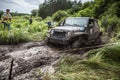 The participant on Jeep passes a deep muddy pit.