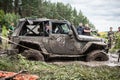 The participant on Jeep passes a deep muddy pit.