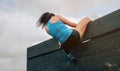 Participant in obstacle course climbing wall