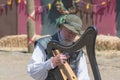 Participant wearing typical clothes playing harp