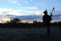 Almaty, Kazakhstan - 06.29.2013 : Silhouette of a player in airsoft gear at night