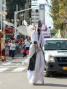 Participants of the annual carnival of Adloyada walking on stilts, dressed in fabulous costumes in Nahariyya, Israel Royalty Free Stock Photo