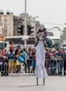 Participants at ÃÂarnival on stilts are walking along the street