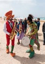 Participants of festival dressed as clowns playing musical instr