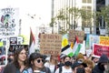 Participants holding signs marching and protesting APEC meeting in San Francisco, CA