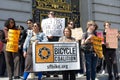 Participants holding signs at a press conf to mark the 10 yr anniversary of the launch of Vision Zero and street safety