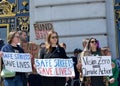 Participants holding signs at a press conf to mark the 10 yr anniversary of the launch of Vision Zero and street safety