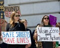 Participants holding signs at a press conf to mark the 10 yr anniversary of the launch of Vision Zero and street safety