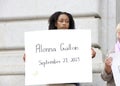 Participants holding signs at a Press conference in San Francisco, CA