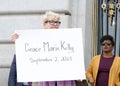 Participants holding signs of recently murdered women at a Domestic Violence Awareness Month Rally