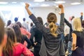 Participants of interactive motivational speech feeling empowered and motivated, hands raised high in the air. Royalty Free Stock Photo