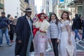Participants pose with a spectator during Easter Bonnet Parade