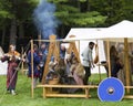 Participants in the Quebec Celtic Festival held in Domaine de Maizerets wearing medieval costumes roaming around fire and tents