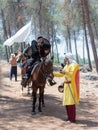 Participants in the reconstruction of Horns of Hattin battle in 1187 one sits on a battle horse, and the second one holds a horse