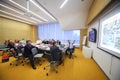 Participants at the table are looking at the board on Business Breakfast