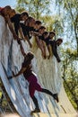 Participants of the Tough Viking obstacle race in Slottsskogen trying to climb a wall..