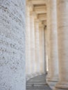 A particular view of the colonnade of St. Peter\'s in the Vatican. Vertical view from inside the corridor and out of focus