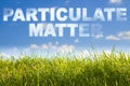 Particulate Matter PM concept image against a green wild grass on sky background