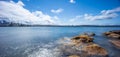 Sydney Harbour with nice rocks in the foreground the soft waves crashing on the shore NSW Australia Royalty Free Stock Photo