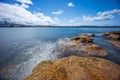 Sydney Harbour with nice rocks in the foreground the soft waves crashing on the shore NSW Australia