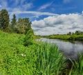 Partly cloudy on a Sunny day on the river Bank. Royalty Free Stock Photo