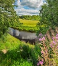 Partly cloudy on a Sunny day on the river Bank. Royalty Free Stock Photo