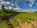 Partly cloudy on a Sunny day on the river Bank. Royalty Free Stock Photo