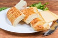 Cheese-stuffed flaky pastry sticks and different cheese close-up