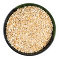 Partly hulled wheat groats in round bowl isolated