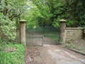 Partly open gates set in stone wall