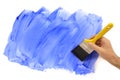 Man holding paintbrush painting blue wall, home decorating, white background, copy space Royalty Free Stock Photo